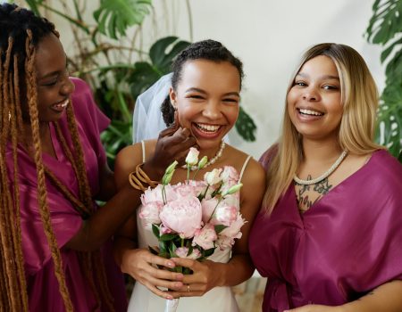 Young bride having fun with bridesmaids during wedding party